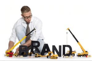 Guy playing with toys building a brand