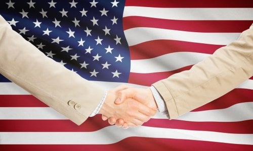 small business shaking hands with government official