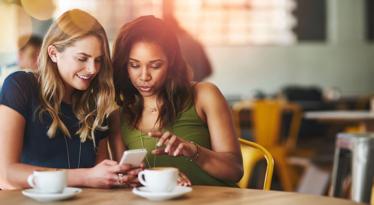 Female customers using free wifi at a coffee shop