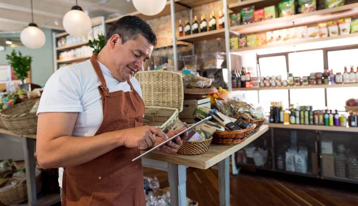 Latino shop owner on tablet device