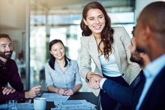 Female entrepreneur shaking hands in meeting