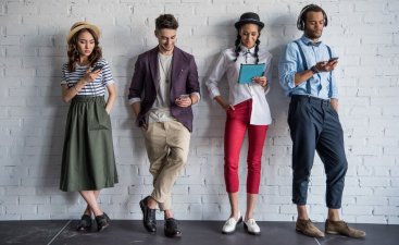 Group of millennials shopping with mobile devices