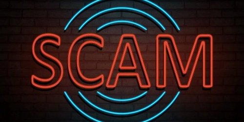 Neon sign that says "scam"