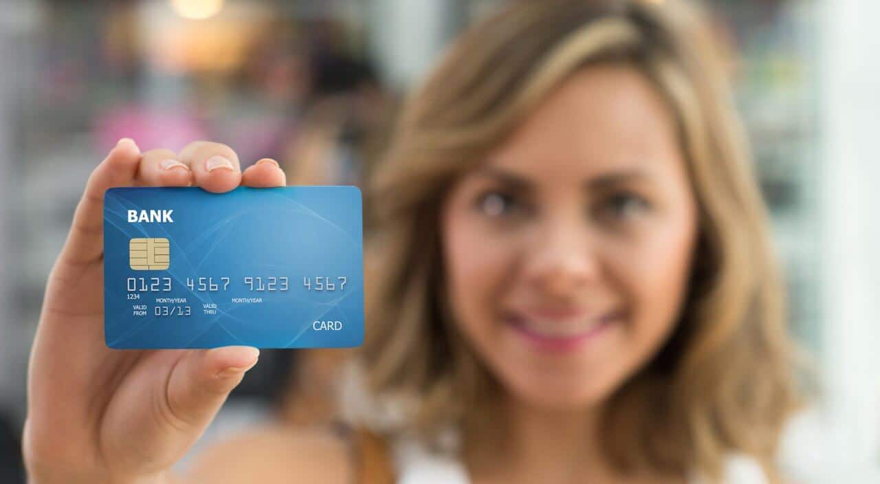 Woman holding up credit card