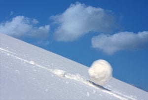 Snowball rolling down a hill. 