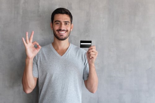 Smiling man with credit card