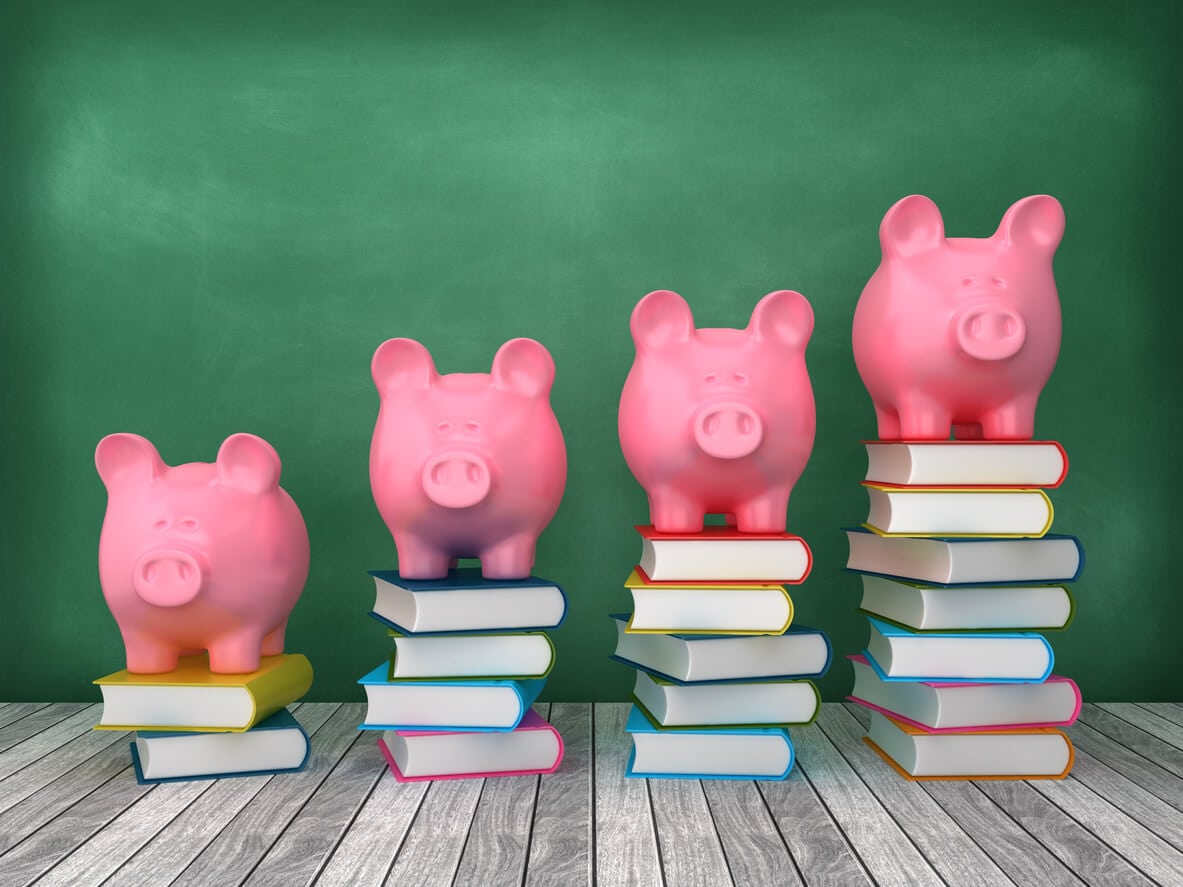 Piggy banks stacked on books