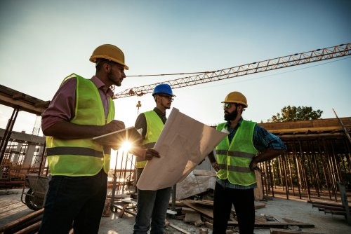Construction workers surveying a construction site