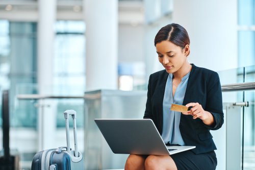Traveling businesswoman using credit card