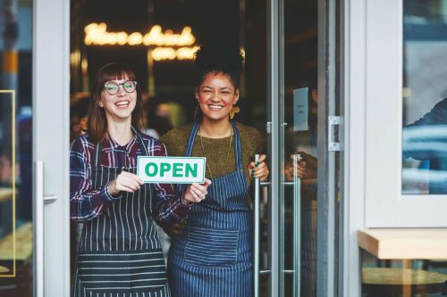 Two young businesswomen opening their small business