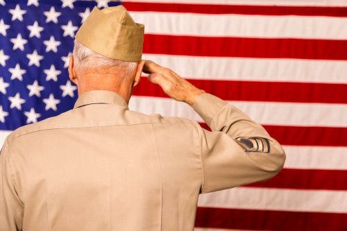 Veteran soldier saluting American flag