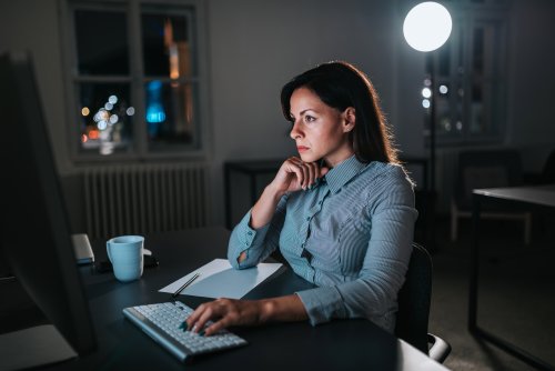 Stressed female business owner sitting at computer