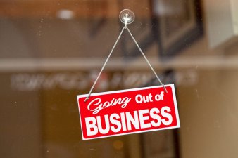 Going out of business sign hanging in window