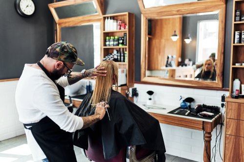 Salon owner cutting a customer's hair