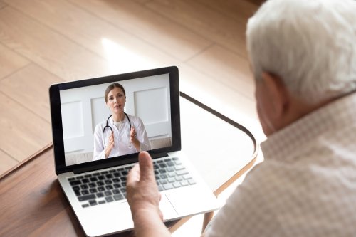 Elderly man speaking to doctor with a virtual call
