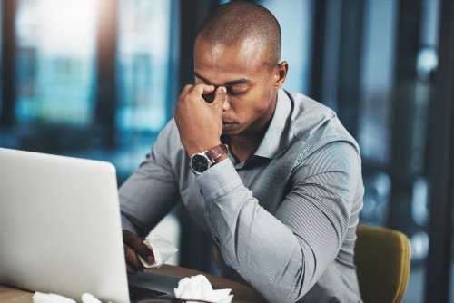 Stressed black business owner at computer