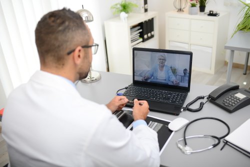 Doctor speaking with a patient through their computer