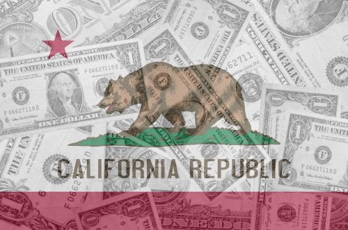 California flag over a pile of dollar bills