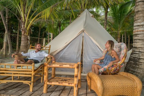 Glamping couple relaxing in camp background