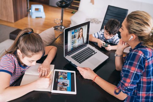 Mother works remotely while kid does remote learning