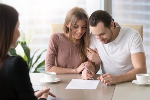 Couple signing for business credit