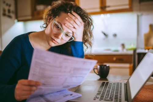 Woman looks through loan documents