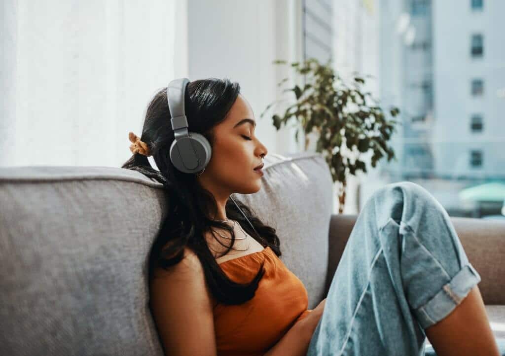 Woman listening to music on couch