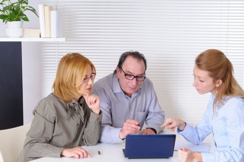 Mature Couple speaking with Financial Advisor