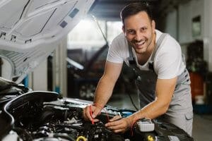 Smiling Mechanic working in Auto Shop