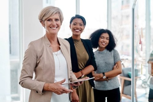 Three Smiling Women in the Workplace