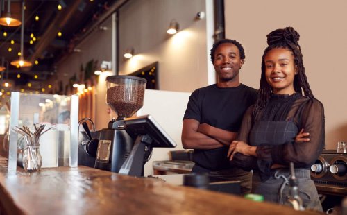 Male and Female Black Coffee Shop Owners Smiling