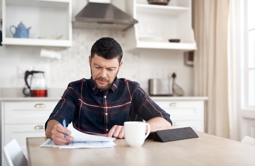 Man uses tablet to look at finances