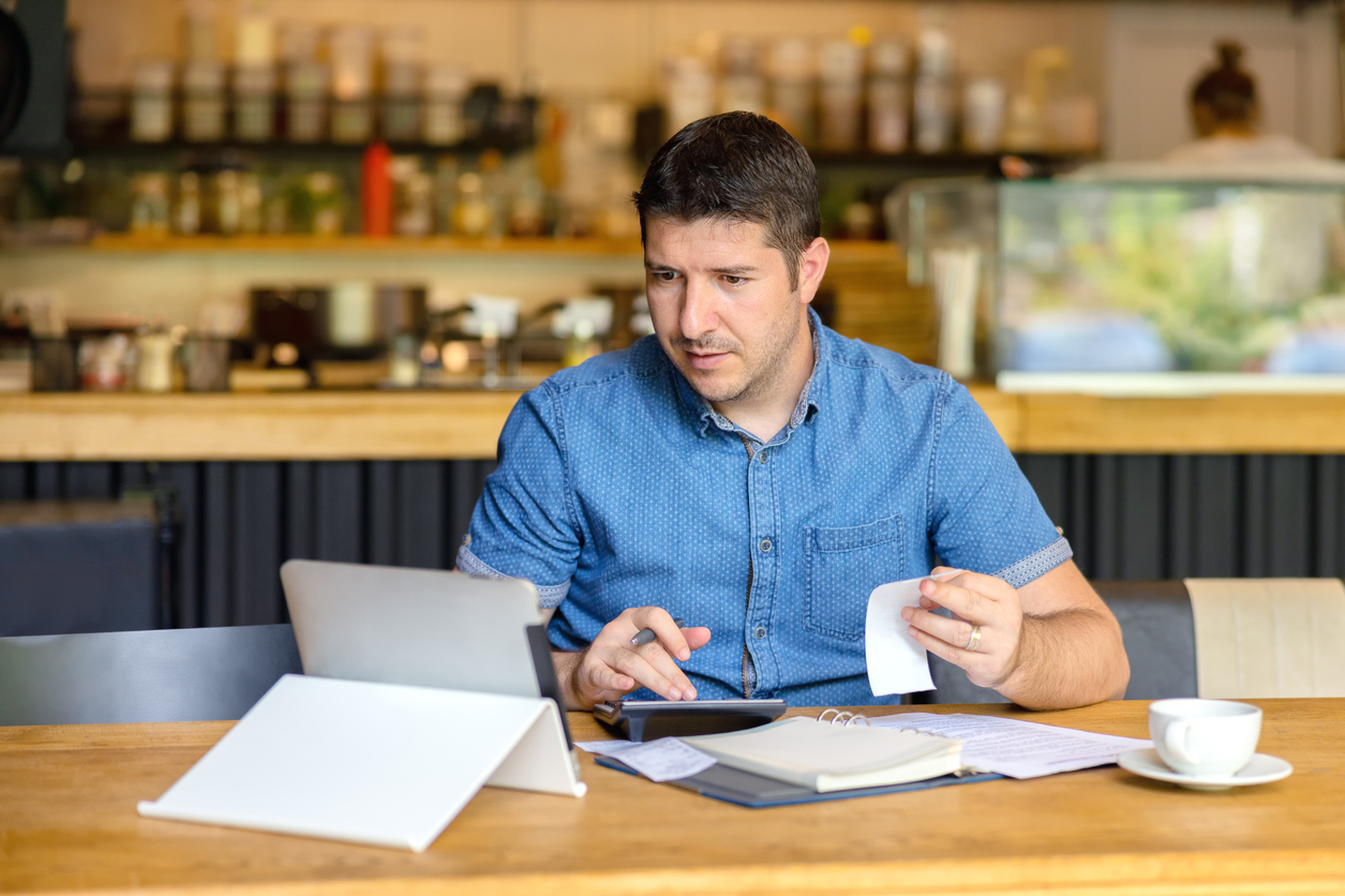 Small Business Owner Going Over Expenses