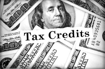 Tax Credits in front of $100 bills