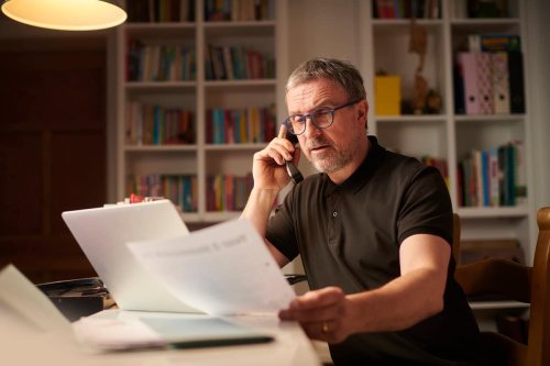 Man working from home going over documents