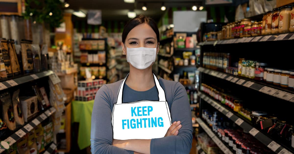 Grocery worker wearing Keep Fighting apron
