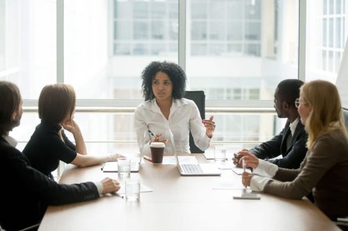 Black female boss leading meeting
