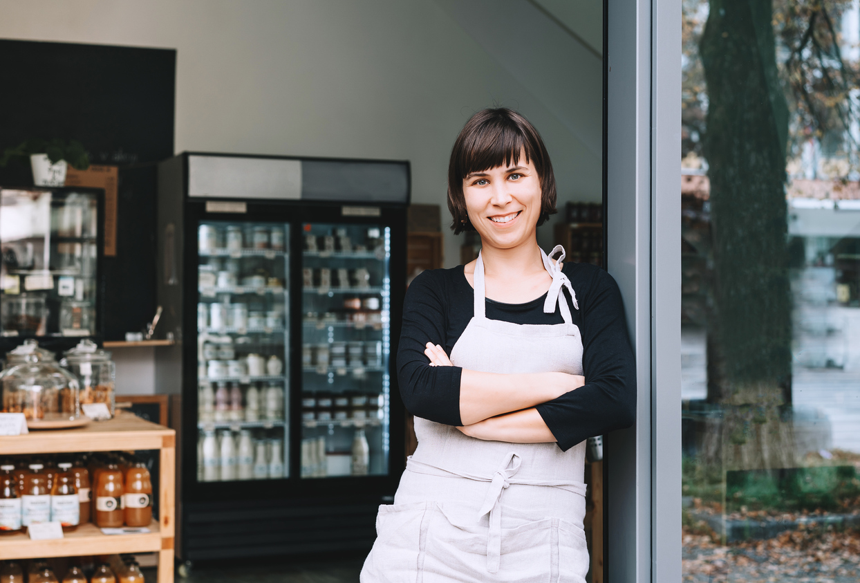 Small Business Owner standing in entryway smiling