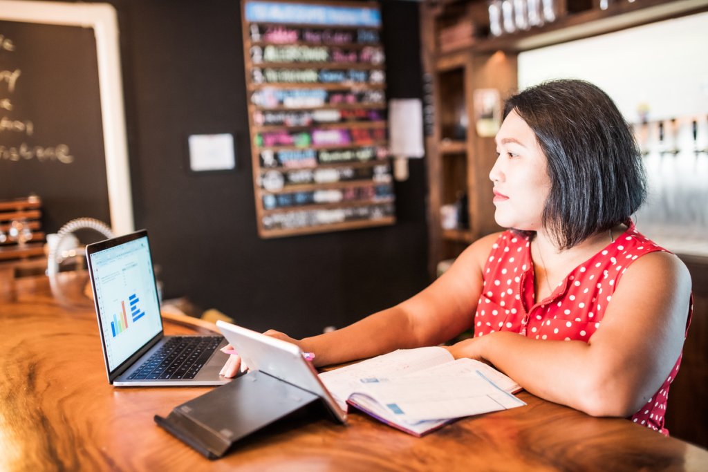Small business owner using a laptop in her bar