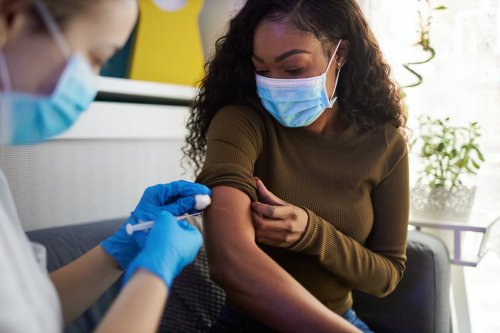 Woman receiving vaccination in an office