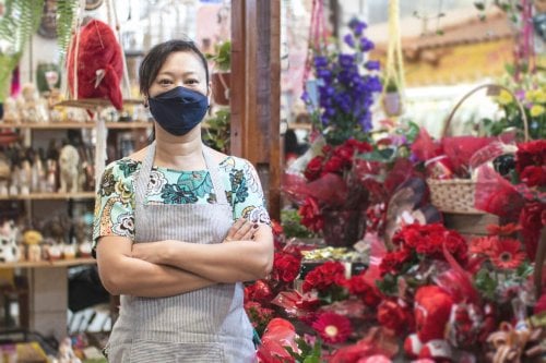 Japanese woman working in her flower shop.