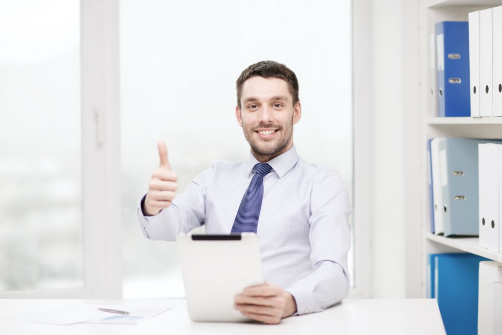 Smiling businessman holding a thumbs up