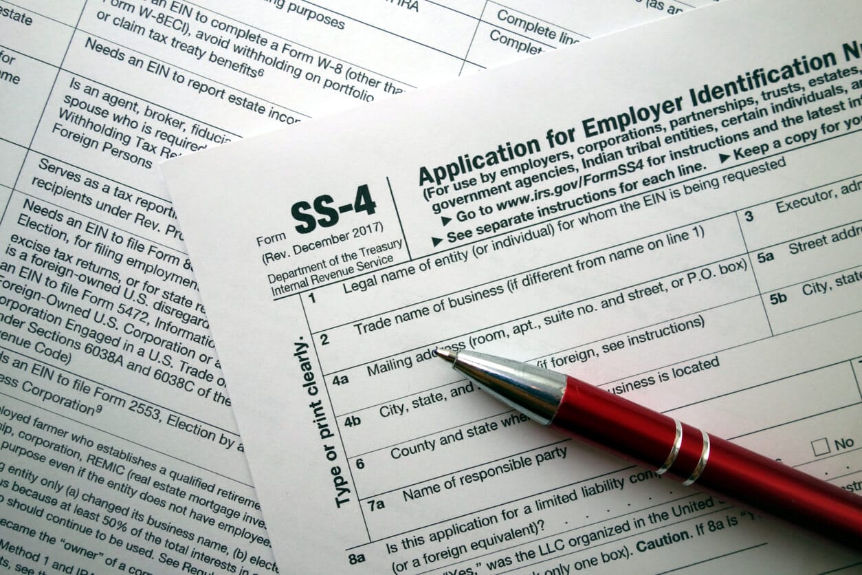 Picture of IRS Form SS-4 with a pen on top of it