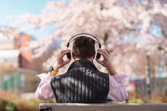 Man putting on headphones to listen to podcast