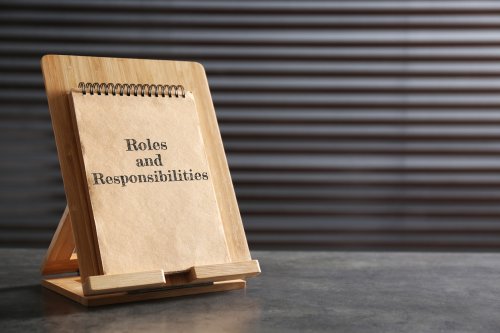 Notepad on table that has roles and responsibilities printed on the front