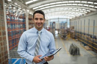 Warehouse manager uses inventory software on a tablet