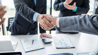 Business men shaking hands after closing a deal