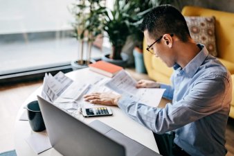 Japanese man working on taxes at desk