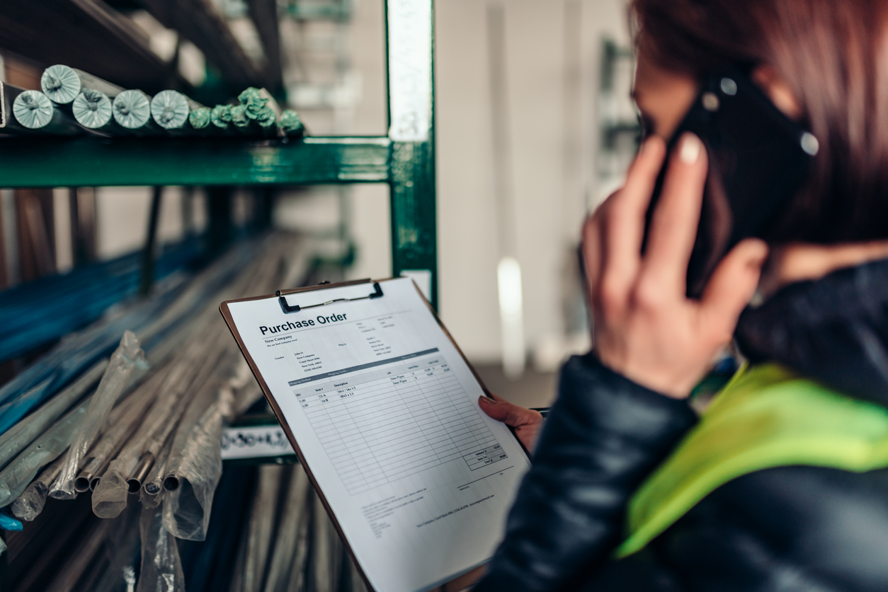 Woman checks purchase order in warehouse