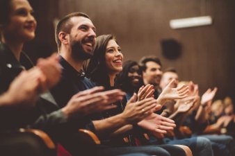 People clapping in a theater
